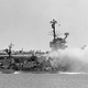 The destroyer USS Rupertus comes alongside Forrestal to help fight the fires (US Navy)